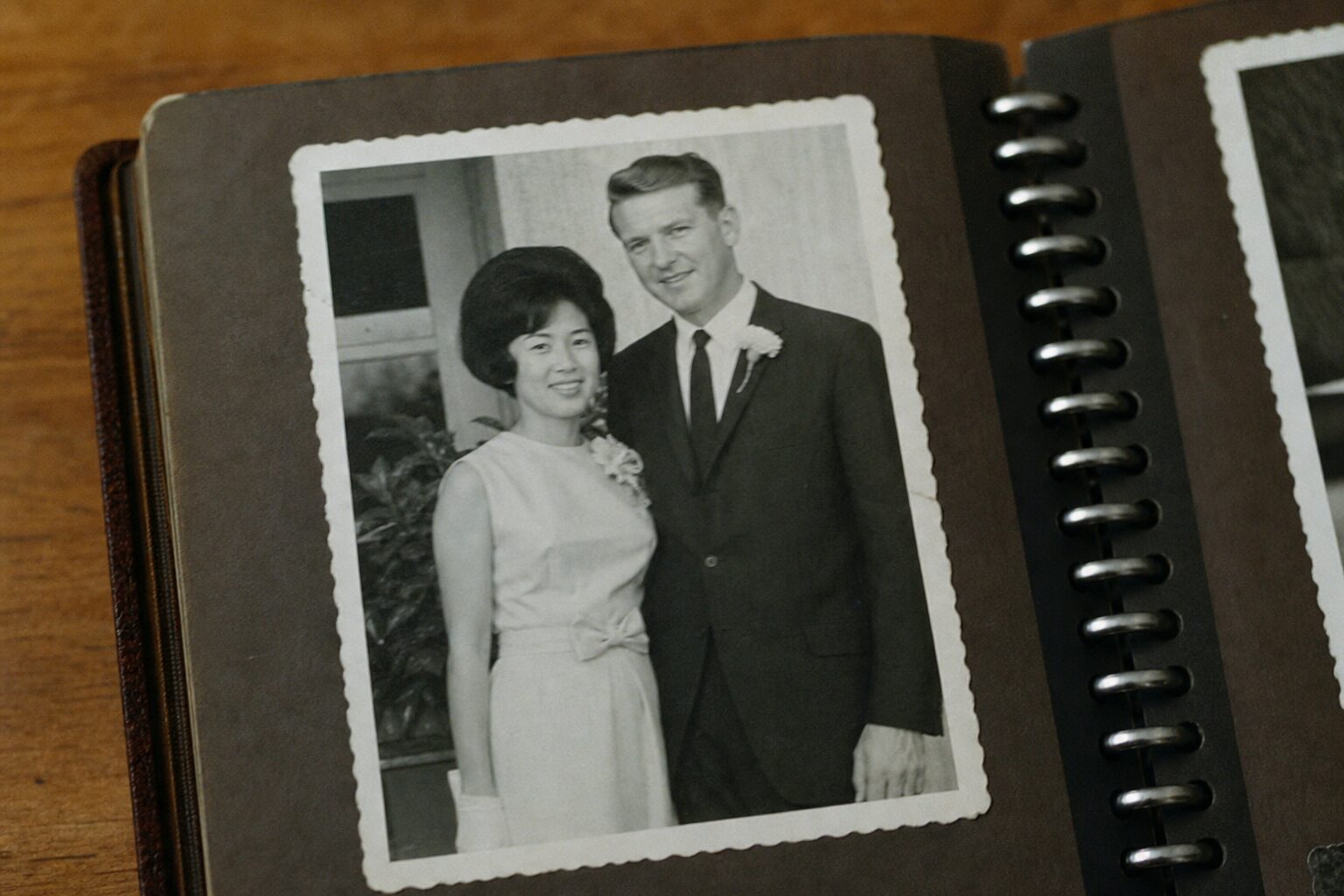 A photo of a Japanese-American woman and Harold in an old album
