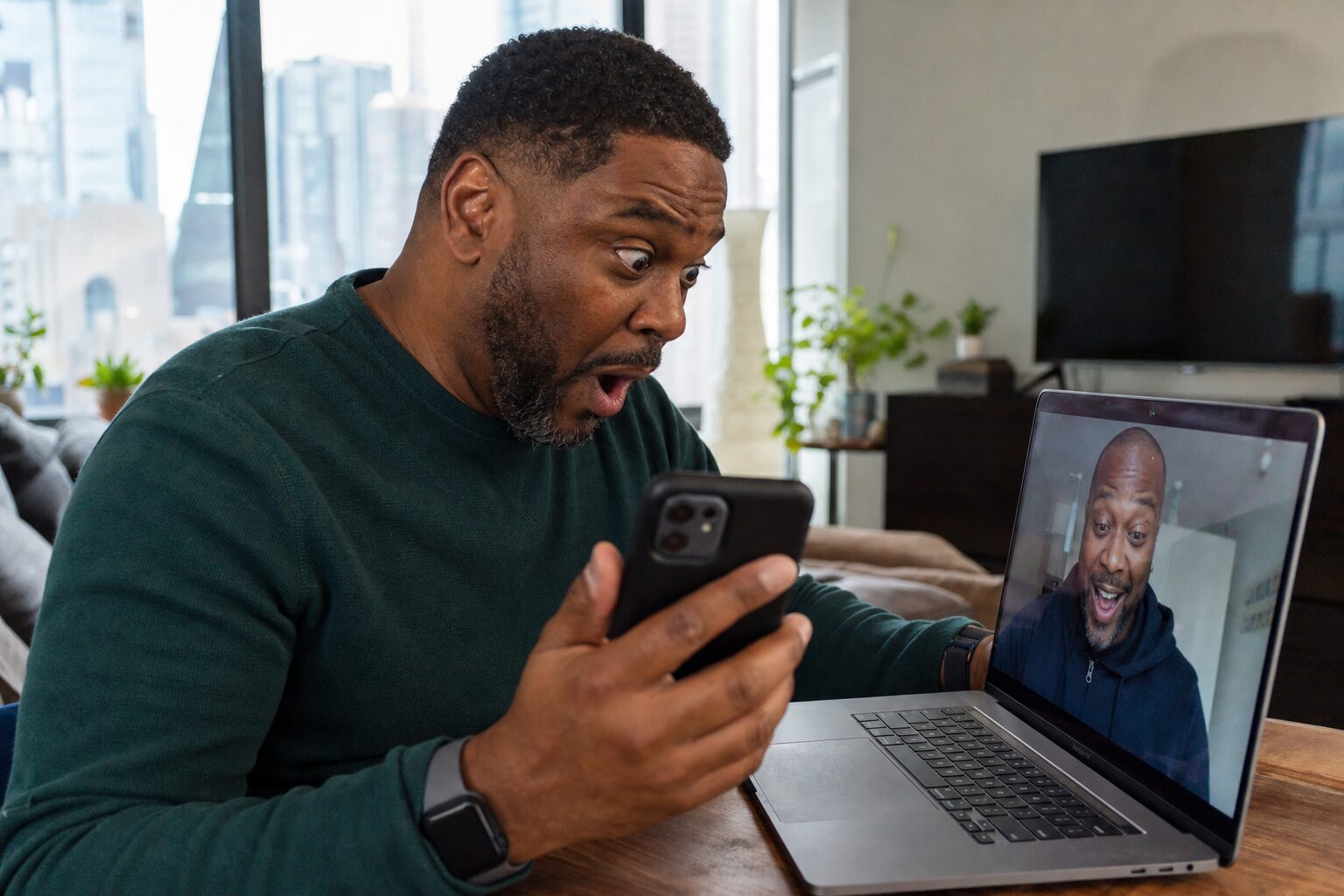 Two men staring at a screen together on a video call