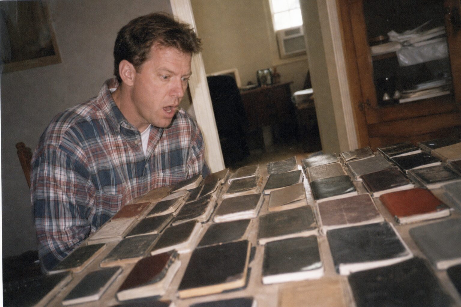 A table covered with forty years' worth of pocket diaries