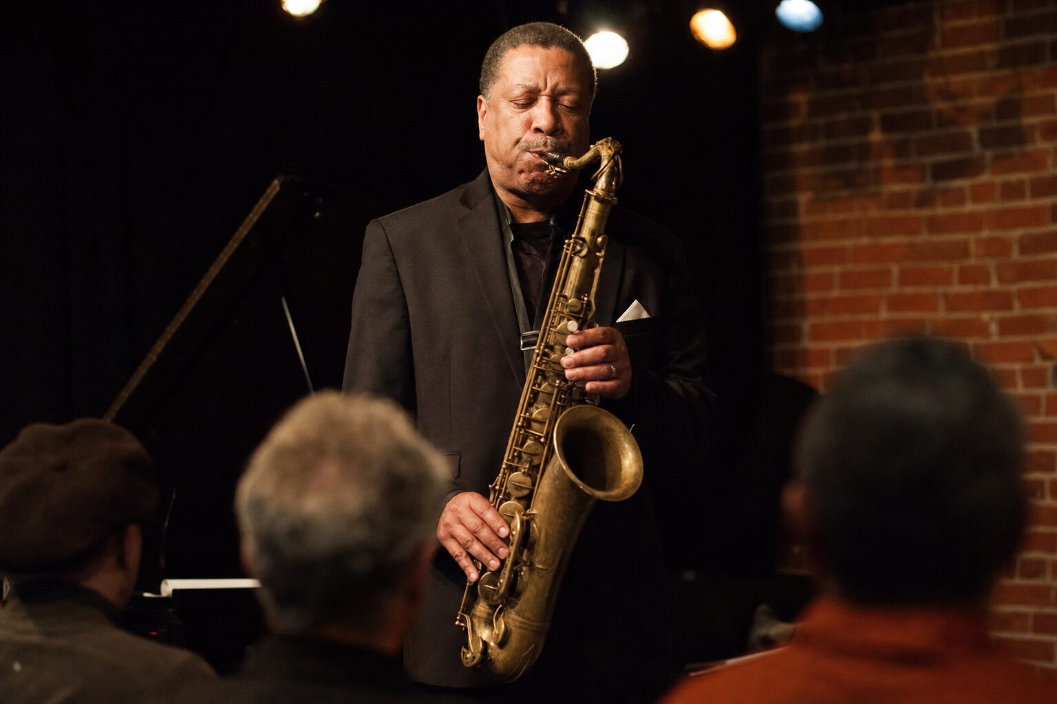 A man standing on a jazz club stage
