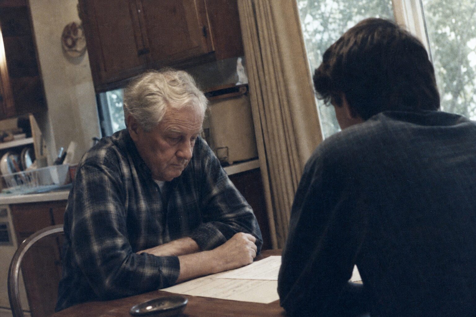 An aging father being told the truth by his son