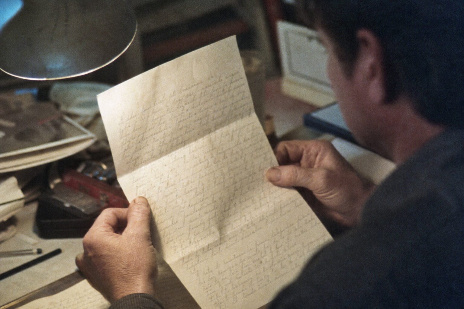 A letter with the handwritten words 'I am a coward' (fiction)
