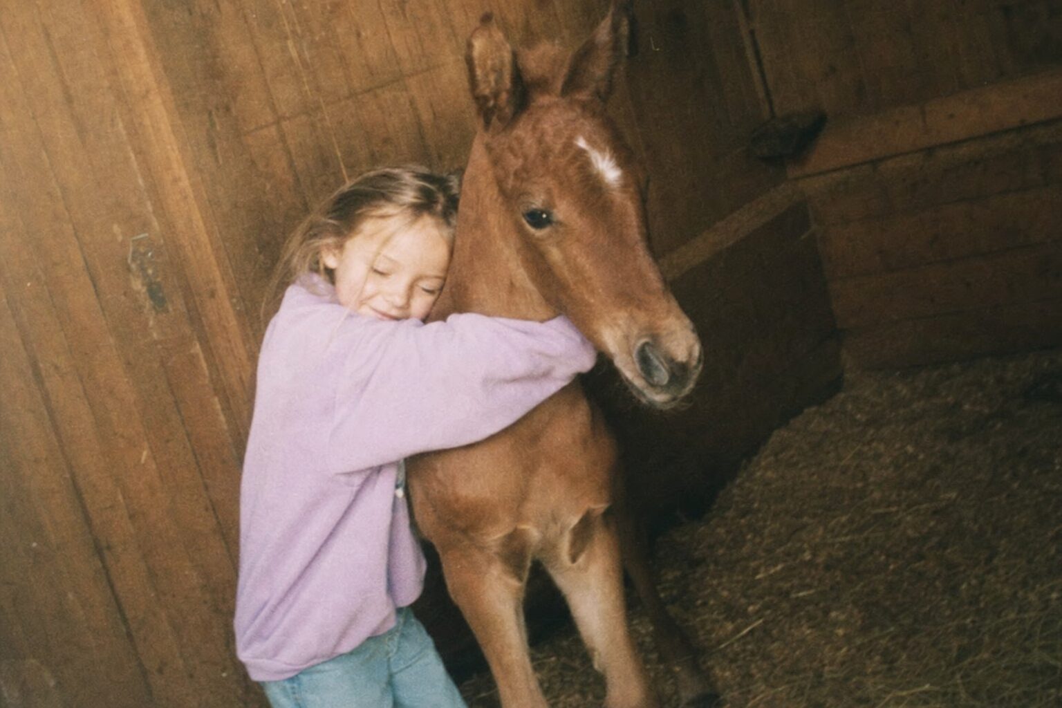 Emma hugging the chestnut foal on her sixth birthday